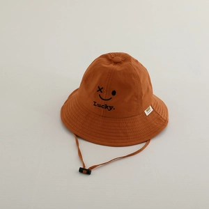 Detail of caramel orange sun hat with Lucky embroidery and adjustable windproof cord