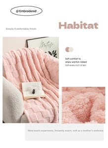 Detailed texture of a soft pink checkerboard plush blanket on a white sofa in a cozy room