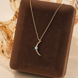 S925 silver crescent necklace with turquoise and white zircon on jewelry stand