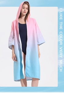Detail of pink and blue gradient hooded beach poncho featuring a front zipper closure