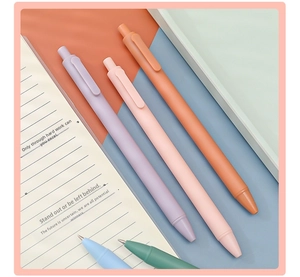 Morandi colored retractable gel pens with matte finish on a minimalist desk setup