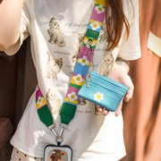 Close-up of floral pattern strap with matching blue coin purse in a lifestyle setting
