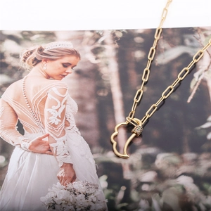 Golden paperclip chain necklace with a crescent moon pendant and colorful zircon stones