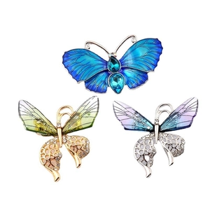 Elegant butterfly brooches in blue, green, and purple enamel with sparkling crystals