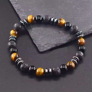 Macro shot of 8mm tiger eye and lava stone beads with white engraved symbols