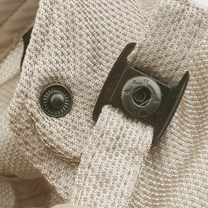 Detail of adjustable metal buckle and breathable mesh fabric on the khaki newsboy cap