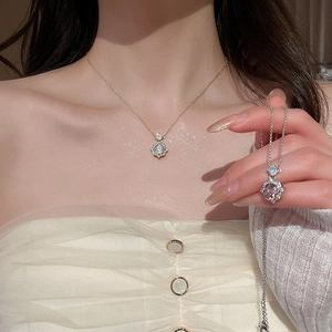 Detail of 14k gold plated rose pendant necklaces with zircon crystals on an elegant model