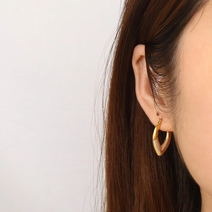 Minimalist gold heart earrings with textured diamond pattern for women