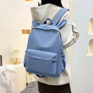 Light blue bunny ear backpack with spacious compartments and adjustable straps for school