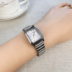 Minimalist square silver steel watch for women with white dial worn on wrist