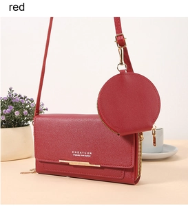 Detail of red textured leather crossbody bag with round coin purse and gold hardware