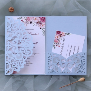 Detailed laser-cut light blue wedding invitation set with floral card and RSVP details