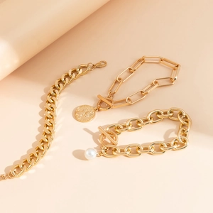 Detailed set of gold curb, paperclip chains with coin pendant and pearl OT buckle charm
