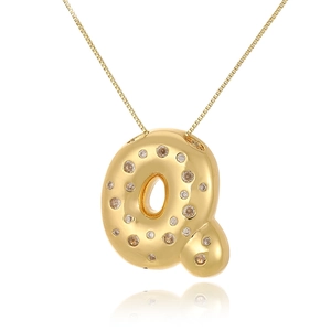 Detailed macro shot of 18k gold plated letter Q pendant with cubic zirconia stones