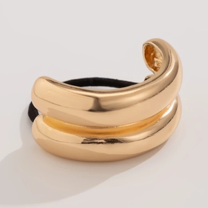 Detailed view of the gold double-layered curved metal buckle on a black elastic hair tie