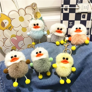 Colorful plush duck keychains in six vibrant colors displayed on a denim background