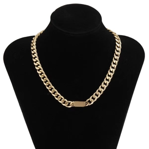 Detail of gold Cuban link chain with a rectangle metal plate on a black neck bust