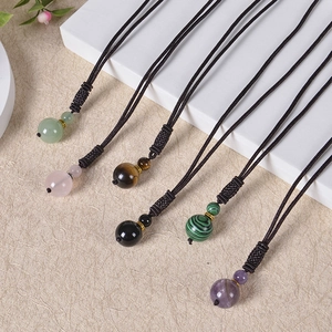 Detail of handmade braided cords with tiger eye and malachite beads for jewelry