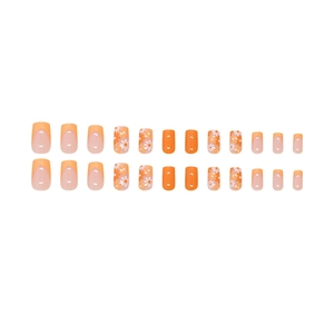 Faux ongles courts carrés orange avec motifs marguerites et design de style français