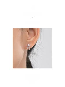 Close-up of S925 sterling silver arrow earrings with micro-paved cubic zirconia crystals