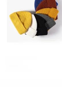 Detail of waffle-knit beanies in multiple colors including yellow, grey and blue