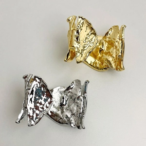 Detail of twisted irregular spring open bangles with gold and silver wrinkled texture