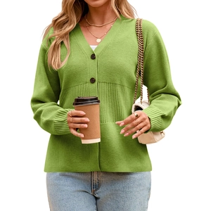 Detail of green knit cardigan featuring V-neckline and large brown buttons