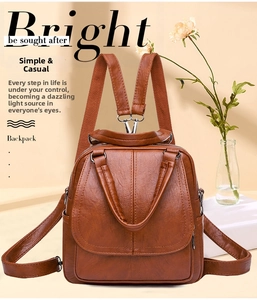 Detalle de mochila vintage en cuero marrón con anillos metálicos y asa superior resistente