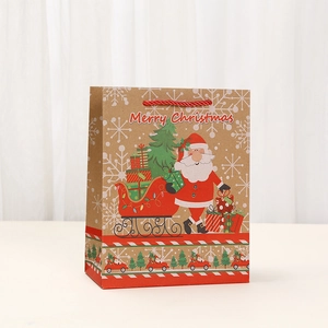 Brown kraft Christmas paper gift bag with festive Merry Christmas print and red handles