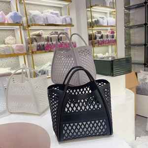 Three hollow mesh tote bags in black, white, and lilac purple shown in a storage setting