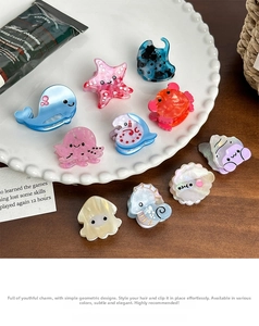 Macro detail of mini ocean animal hair claws with colorful marble texture on a white plate