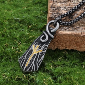 Macro shot of vintage Viking rune pendant with gold Algiz symbol on rustic wood texture