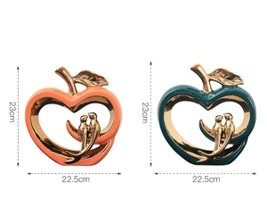 Detail of luxury ceramic apple ornaments with hollow heart and golden birds