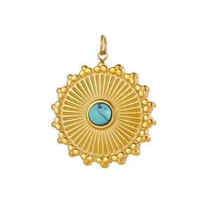 Macro detail of a vintage gold sun pendant featuring an emerald green natural stone center