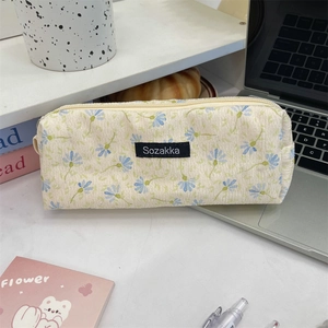 Floral corduroy stationery pouch with top zipper and woven label for organization