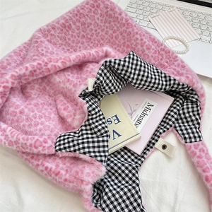 Detail view of pink leopard faux fur tote bag with checkered lining and soft plush texture