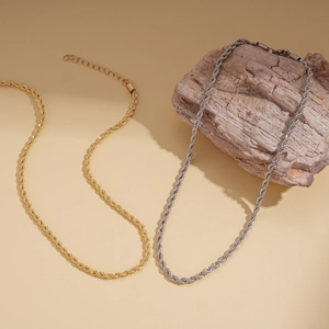 Detailed macro view of gold and silver rope chain necklaces with lobster clasp and extensions