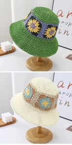 Close-up of hand-crocheted bucket hat details with floral patterns in green and beige