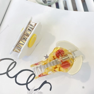 Cute acetate hair claws featuring a white flower and colorful confetti shark clip design