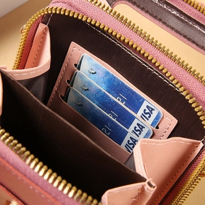 Dusty pink leather phone bag showing interior card slots and high-quality gold zipper