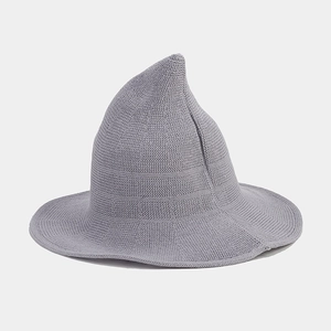 Detailed close-up of grey knitted witch hat showing fine crochet texture and pointed top