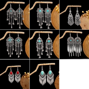 Detail view of Bohemian turquoise earrings with vintage silver tassels and tribal patterns