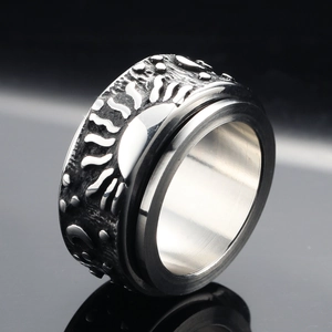 Vintage stainless steel spinner ring featuring rotating sun moon and star engravings