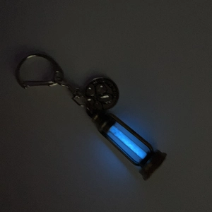 Vintage hourglass keychain with blue luminous glow and embossed round pendant