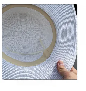 Detail of white straw sun hat with adjustable inner drawstring and beige sweatband