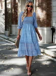 Detail view of floral print blue midi dress featuring square neck and puff sleeves