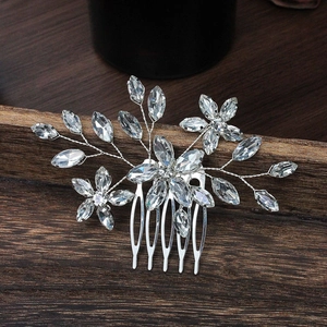 Detail of silver bridal hair comb with handmade crystal flowers and rhinestones