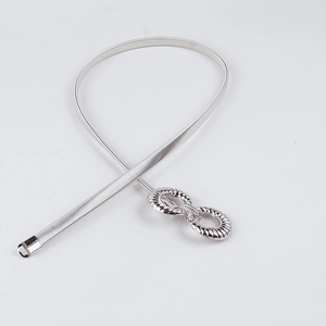 Detail showing silver stretch metal belt with interlocking double ring knot buckle