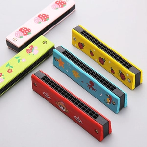 Close-up of five colorful wooden harmonicas with various animal and fruit patterns for kids