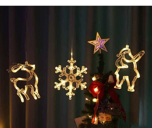 Detail view of warm white LED Reindeer and Snowflake suction lights on window